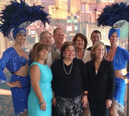 While enjoying an evening with friends at the NCSL Legislative Summit, we found ourselves surrounded by showgirls. [Pictured front row - Beth Loudy, SGAC; Elizabeth Z. Bartz, State and Federal Communications, Inc.; and Katrina Iserman, Sunovion Pharmaceuticals.  Back row - showgirl, Ron Burns, Dan Felton, Phillips; Jean Cantrell, Phillips; Joe Gregorich, Apollo; and showgirl.]